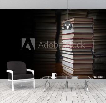 Picture of Stack of books against the background of a number of books a place for an inscription